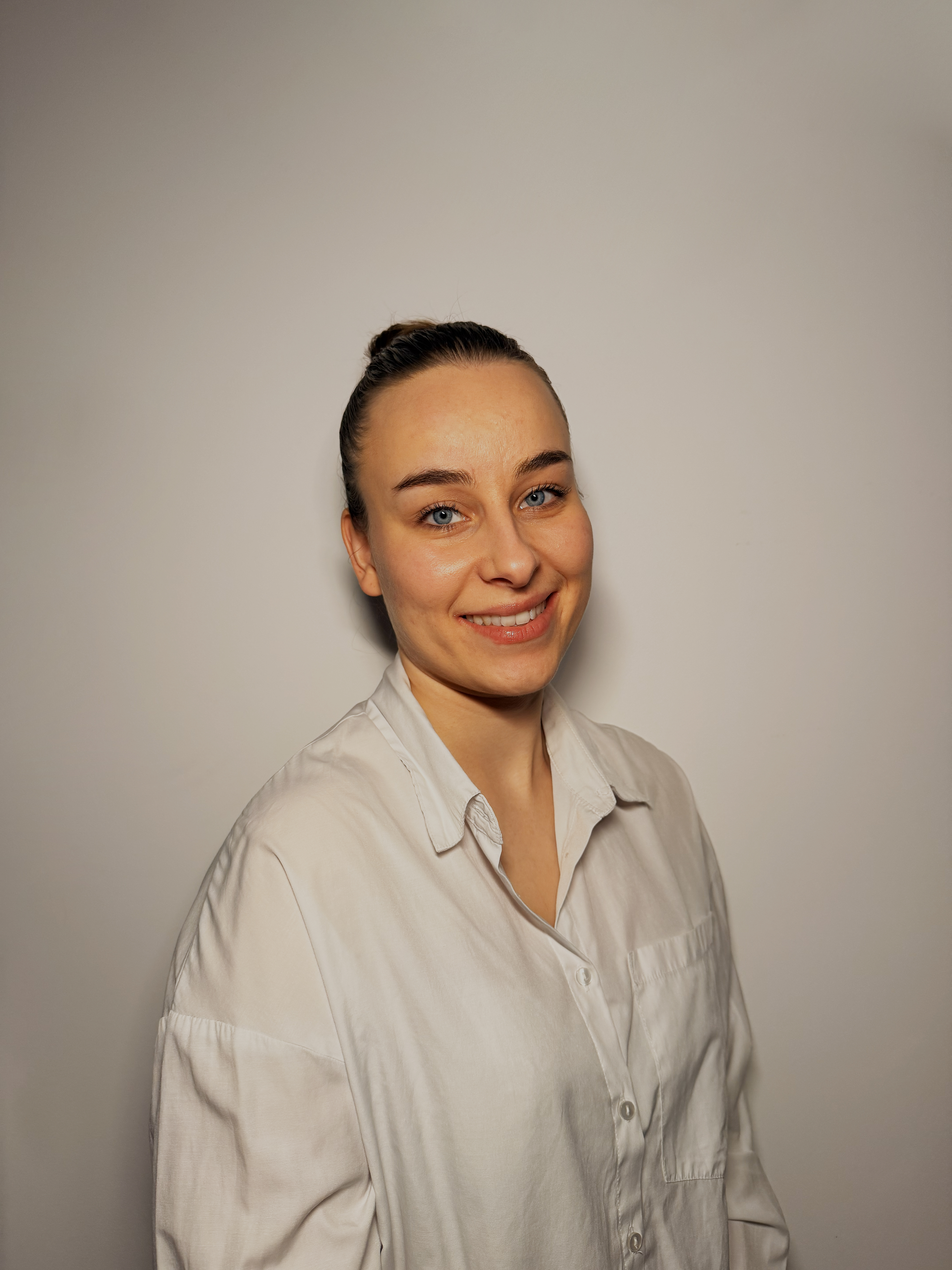 Portrait of a smiling woman in a spa environment.