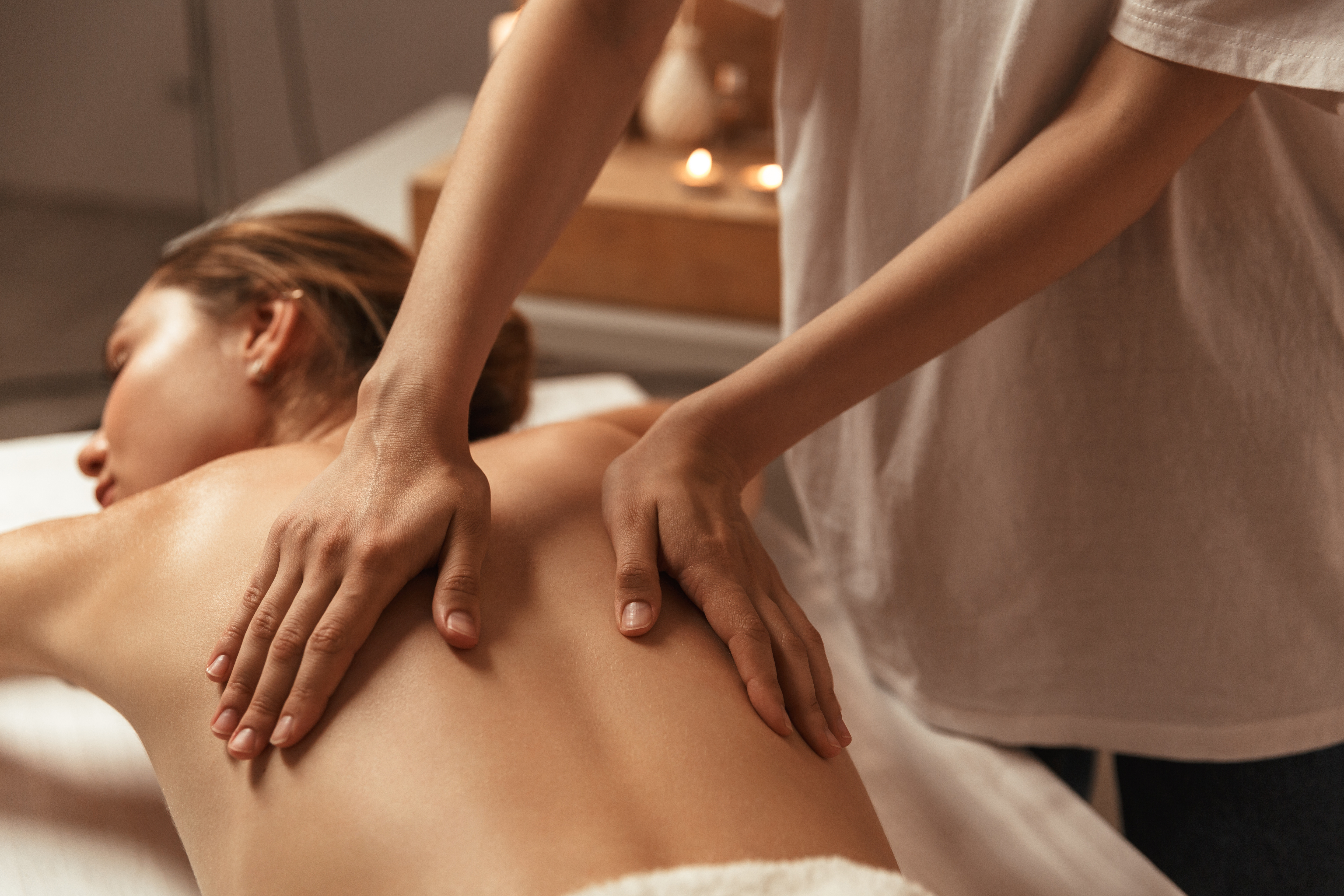 Close-up of a person receiving a relaxing face massage.